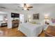 Bedroom with wood floors, fireplace, TV, and ensuite bathroom at 5478 Landis Ave, Port Orange, FL 32127