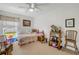 Well-lit bedroom with carpet, toys, a ceiling fan, and a window with a view at 5478 Landis Ave, Port Orange, FL 32127