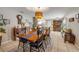 Spacious dining room with wooden table, decorative lighting, and view to the kitchen at 5478 Landis Ave, Port Orange, FL 32127