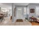 Inviting entryway with light tile floors and view to the kitchen, decorated with plants and wall art at 5478 Landis Ave, Port Orange, FL 32127
