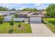 Charming single-story home featuring a two-car garage, well-manicured lawn, and white picket fence at 5478 Landis Ave, Port Orange, FL 32127