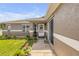 Home's entrance featuring plants, walkway, and front door at 5478 Landis Ave, Port Orange, FL 32127