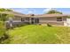 Landscaped front yard with lawn, flowers and tidy walkway at 5478 Landis Ave, Port Orange, FL 32127
