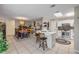Open-concept kitchen and dining area with a skylight, stainless steel appliances, and breakfast bar at 5478 Landis Ave, Port Orange, FL 32127