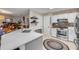 Open kitchen featuring an island with a sink, modern appliances, and connection to the dining area at 5478 Landis Ave, Port Orange, FL 32127