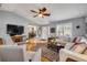 Comfortable living room with hardwood floors, TV, and view into the entryway and kitchen at 5478 Landis Ave, Port Orange, FL 32127