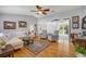 Cozy living room featuring hardwood floors, comfortable seating, and sliding doors to the patio at 5478 Landis Ave, Port Orange, FL 32127