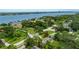 Aerial view of a home in a neighborhood with mature trees with views of the waterfront in the distance at 556 N Beach St, Ormond Beach, FL 32174