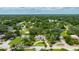 Aerial view of a charming home nestled in a serene neighborhood, surrounded by lush greenery and mature trees at 556 N Beach St, Ormond Beach, FL 32174
