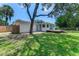A home's backyard has a well-maintained lawn and a patio perfect for relaxing or entertaining guests at 556 N Beach St, Ormond Beach, FL 32174