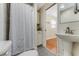 Cozy bathroom featuring a pedestal sink, patterned floor tile, and storage at 556 N Beach St, Ormond Beach, FL 32174