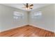 Bright, simple bedroom featuring hardwood floors, a ceiling fan, and natural light at 556 N Beach St, Ormond Beach, FL 32174
