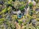 Secluded home surrounded by lush greenery and featuring a screened-in pool at 5721 John Anderson Hwy, Flagler Beach, FL 32136