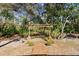 Backyard garden path featuring a wooden archway and lush vegetation at 5721 John Anderson Hwy, Flagler Beach, FL 32136