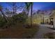 Beautiful backyard with a screened-in pool area and lush greenery at 5721 John Anderson Hwy, Flagler Beach, FL 32136