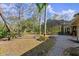 Expansive backyard with a large screened-in enclosure and mature trees at 5721 John Anderson Hwy, Flagler Beach, FL 32136