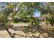 Lush backyard with mature trees and landscaping creating a serene outdoor space at 5721 John Anderson Hwy, Flagler Beach, FL 32136