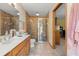 Bathroom showcasing double sink vanity, tiled shower, and classic design at 5721 John Anderson Hwy, Flagler Beach, FL 32136
