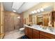 Bathroom featuring double sink vanity, a glass shower, and neutral tile at 5721 John Anderson Hwy, Flagler Beach, FL 32136