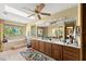 Bathroom featuring dual vanities, tile flooring, a soaking tub and a garden window with a private backyard view at 5721 John Anderson Hwy, Flagler Beach, FL 32136