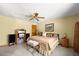 Cozy bedroom with ceiling fan, carpet floors and bright natural lighting at 5721 John Anderson Hwy, Flagler Beach, FL 32136