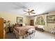 Inviting bedroom with a ceiling fan and natural light from the adjacent windows at 5721 John Anderson Hwy, Flagler Beach, FL 32136
