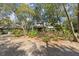 Charming home with lush landscaping and mature trees creating a welcoming approach at 5721 John Anderson Hwy, Flagler Beach, FL 32136