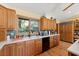 Traditional kitchen with light wood cabinets, hard wood floors and stainless steel appliances at 5721 John Anderson Hwy, Flagler Beach, FL 32136