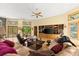 Spacious living room featuring a comfortable sofa, ceiling fan, and large windows overlooking the outdoors at 5721 John Anderson Hwy, Flagler Beach, FL 32136