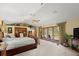 Serene main bedroom with plush carpeting, a ceiling fan, and access to the backyard through elegant French doors at 5721 John Anderson Hwy, Flagler Beach, FL 32136