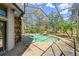 Screened-in pool with a rock waterfall and lush landscaping at 5721 John Anderson Hwy, Flagler Beach, FL 32136