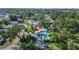 Aerial view of property featuring a pool, waterway access, and lush tree coverage at 61 E Bayshore Dr, Port Orange, FL 32127