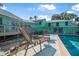 Lounge chairs invite you to relax by the pool in this peaceful backyard setting at 61 E Bayshore Dr, Port Orange, FL 32127