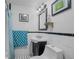 Compact bathroom featuring black and white tile, a sink, and a toilet at 61 E Bayshore Dr, Port Orange, FL 32127