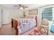 Cozy bedroom with floral bedding, a ceiling fan, and a natural light window at 61 E Bayshore Dr, Port Orange, FL 32127