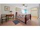 Bedroom with wood framed bed, ceiling fan, side table, and tile floors at 61 E Bayshore Dr, Port Orange, FL 32127