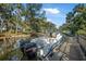 View of large boat at dock with twin Suzuki motors and waterfront canal access at 61 E Bayshore Dr, Port Orange, FL 32127