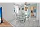 Cozy dining area with a round table, chairs, and an adjacent kitchen view at 61 E Bayshore Dr, Port Orange, FL 32127