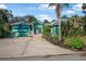 Inviting single-Gathering home showcasing a vibrant exterior, ample driveway space, and lush landscaping at 61 E Bayshore Dr, Port Orange, FL 32127