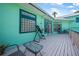 Beautiful exterior of home with a deck overlooking mature trees and pool at 61 E Bayshore Dr, Port Orange, FL 32127