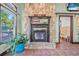 Close-up of stone fireplace with an entrance to a bathroom and views of the outdoor porch at 61 E Bayshore Dr, Port Orange, FL 32127