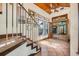 Grand foyer featuring tile floors, wood ceilings, a decorative staircase, and an open living space at 61 E Bayshore Dr, Port Orange, FL 32127