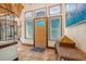 Inviting foyer featuring tile flooring, a striking front door, and natural light from several windows at 61 E Bayshore Dr, Port Orange, FL 32127