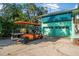 Garage with parking for two cars, and an orange golf cart parked on the driveway at 61 E Bayshore Dr, Port Orange, FL 32127