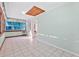 Bright hallway with tiled floors, natural light, and an exterior door at 61 E Bayshore Dr, Port Orange, FL 32127
