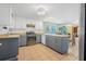 Bright kitchen featuring two-tone cabinets, tile floors, modern appliances, and an open layout at 61 E Bayshore Dr, Port Orange, FL 32127