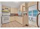 Functional kitchen with an oven, sink, cabinets, and doorway to sunroom at 61 E Bayshore Dr, Port Orange, FL 32127