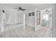 Bright living room with tile floors, ceiling fan, and direct access to dining area at 61 E Bayshore Dr, Port Orange, FL 32127