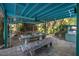 Covered outdoor patio with dining table and benches, ideal for gatherings at 61 E Bayshore Dr, Port Orange, FL 32127