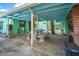 Charming outdoor patio featuring covered seating area and outdoor kitchen for entertaining at 61 E Bayshore Dr, Port Orange, FL 32127